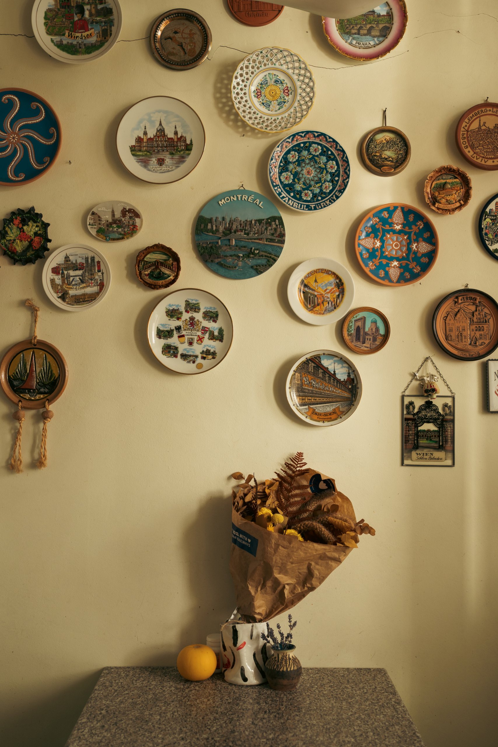 A wall with decorative souvenir plates from around the world.