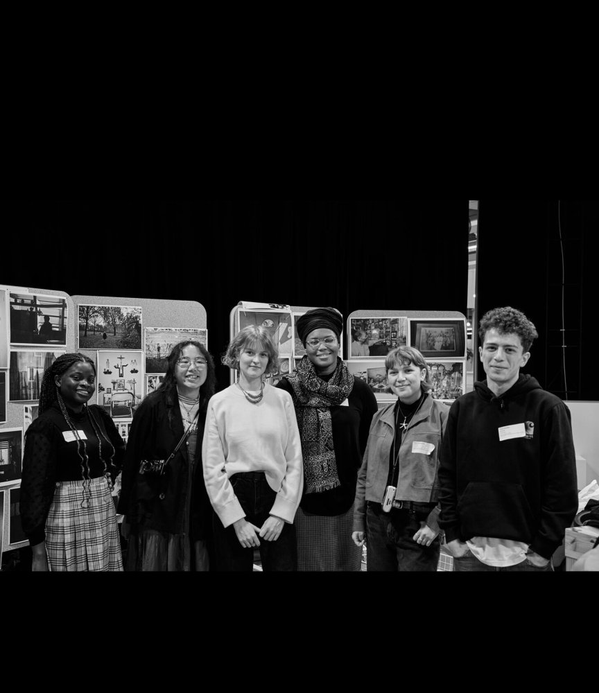 The six mentees standing in front of their photo exhibition.