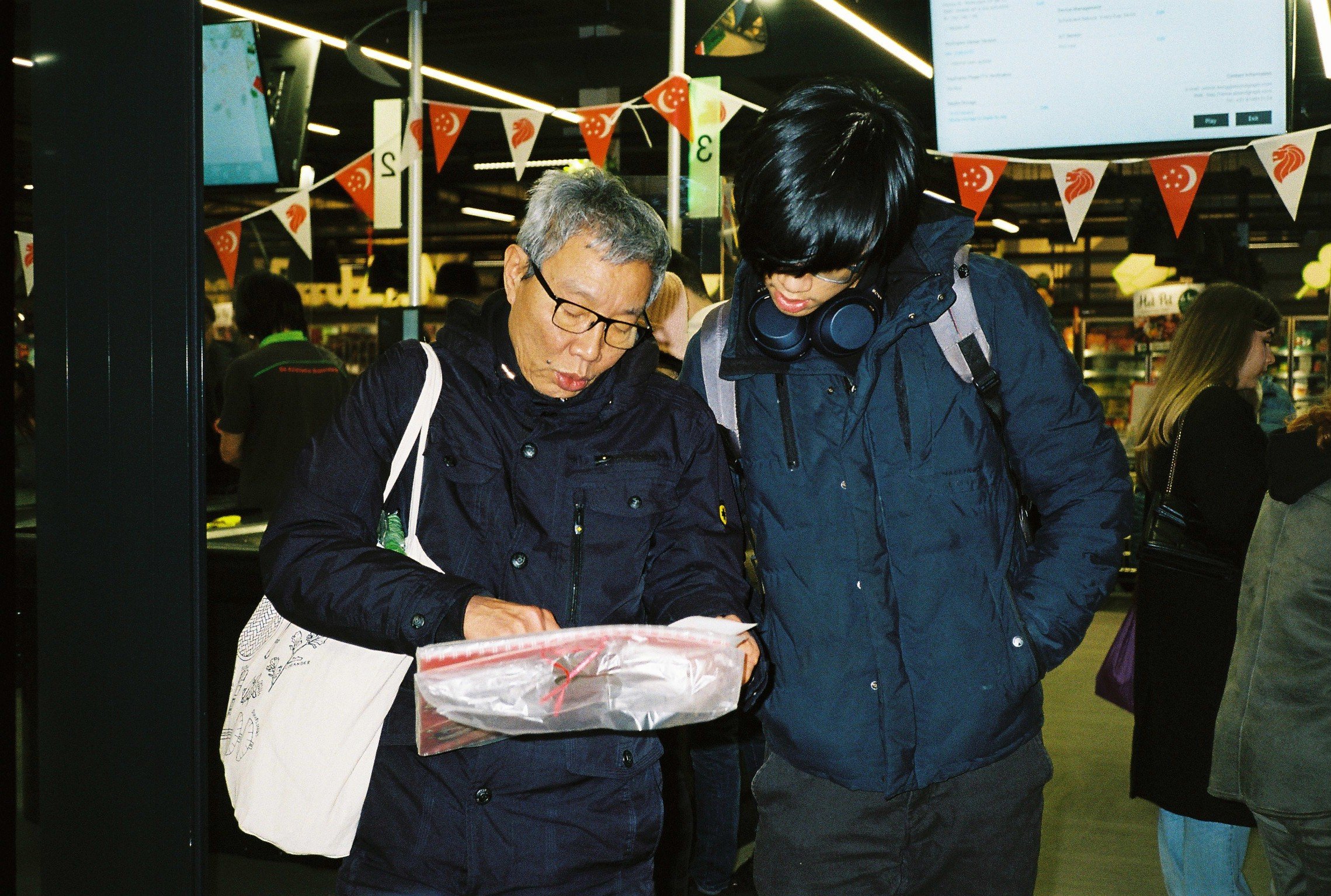 Trams father and brother at a market.