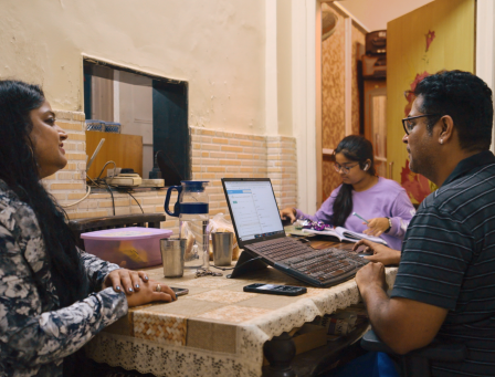 Family sitting at the table together, working and chatting