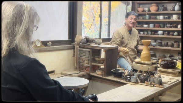Annie taking photos of Yusuke in his ceramics studio.