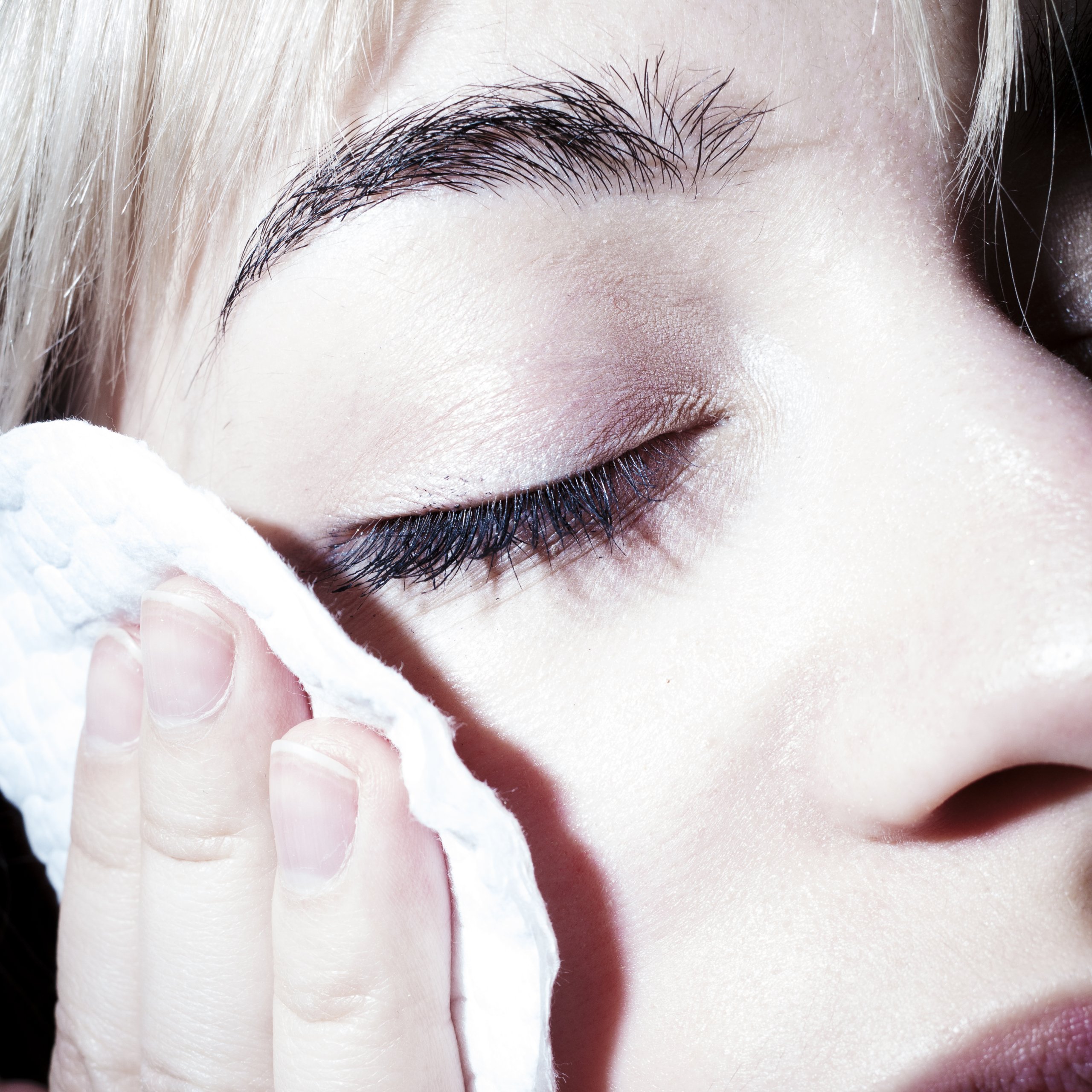 Closeup of Toma's girlfriend removing makeup with a makeup pad.