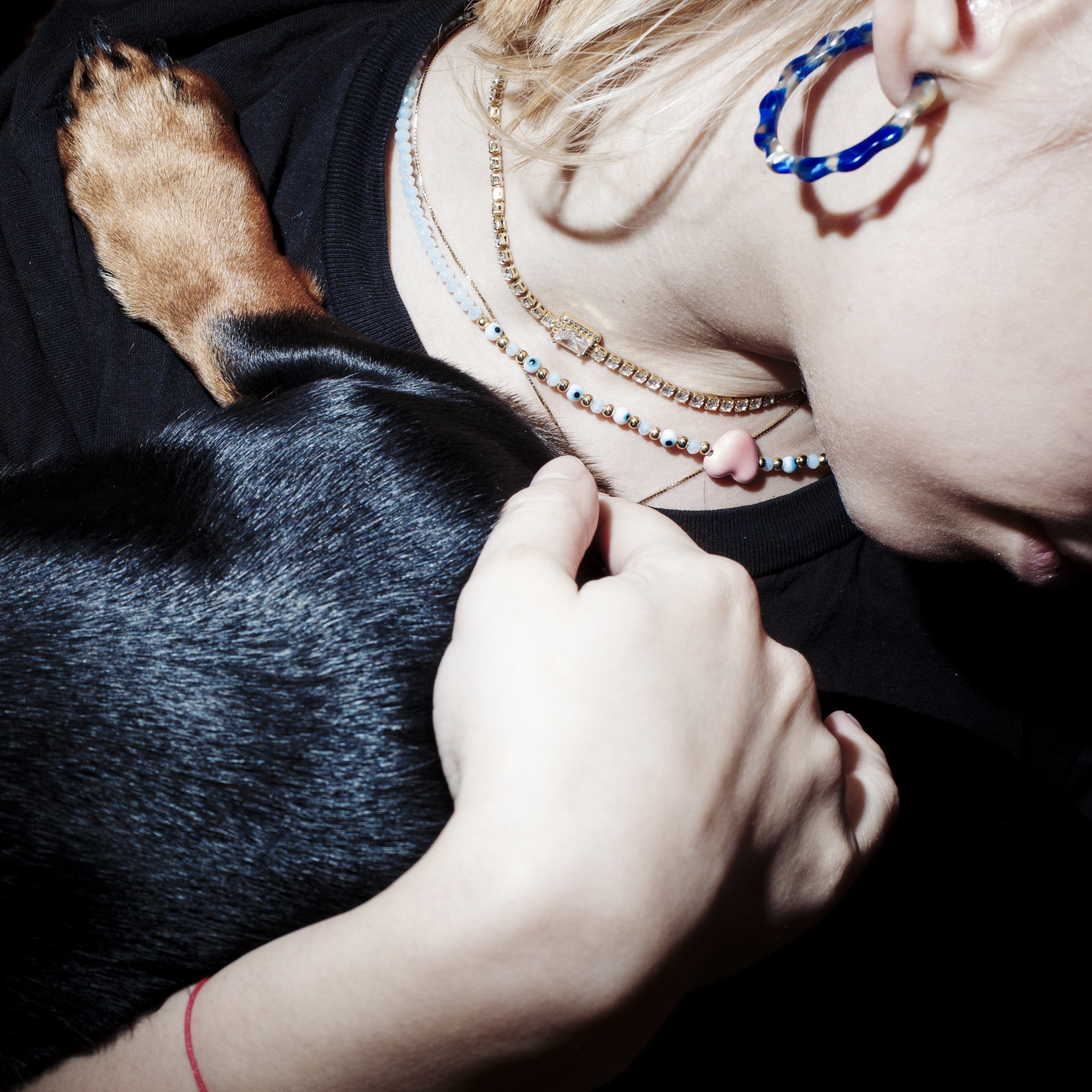 Closeup of Toma's girlfriend holding their dog.