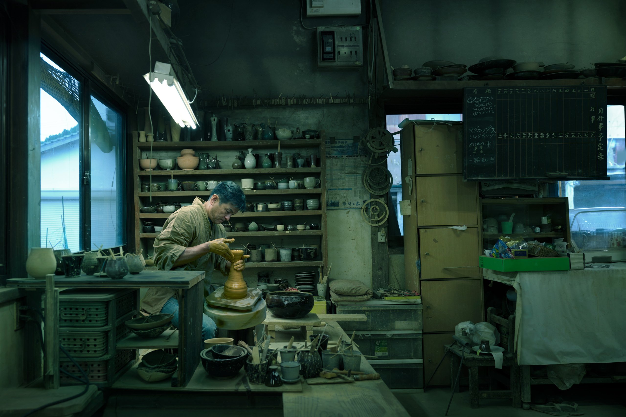 Yusuke working on a ceramics piece in his pottery studio.